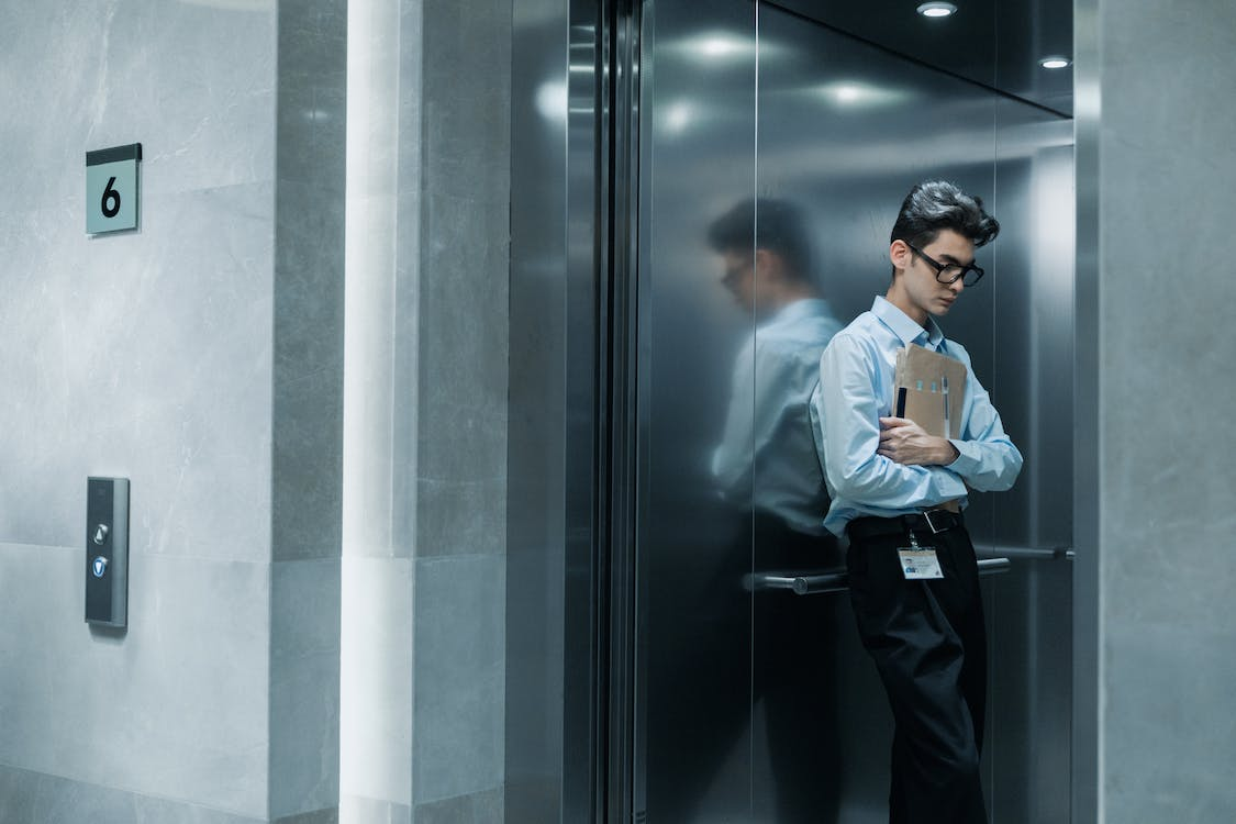 A person is performing an elevator inspection